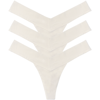 Set of three cream-colored thong underwear pieces on a white background