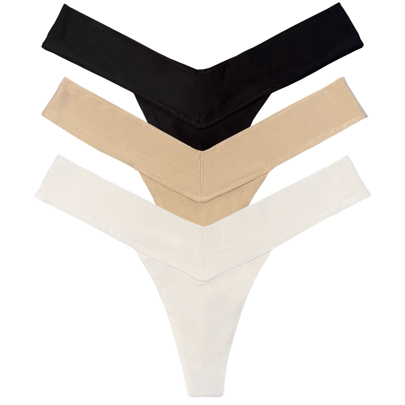 Three pairs of womens thongs in black, beige, and white on a white background