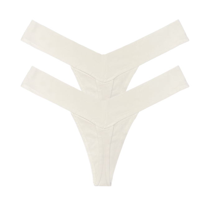 Two white V-shaped luxury women’s thong panties, multipack back view flat lay